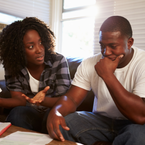 Man and woman looking worried over finances.