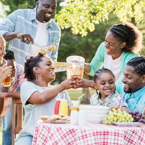 family gathered around a table enjoying bbq