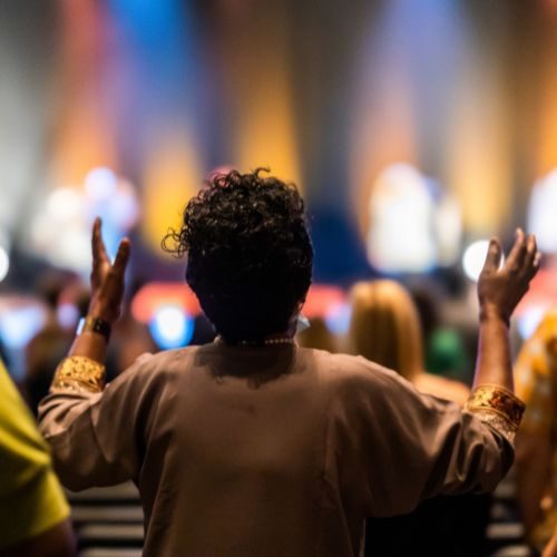 The back of a woman worshipping in service